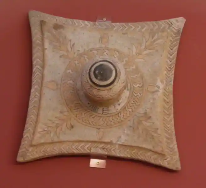 Four-pointed cross and fine geometric and floral designs on glazed brick offered by Assurnasirpal II